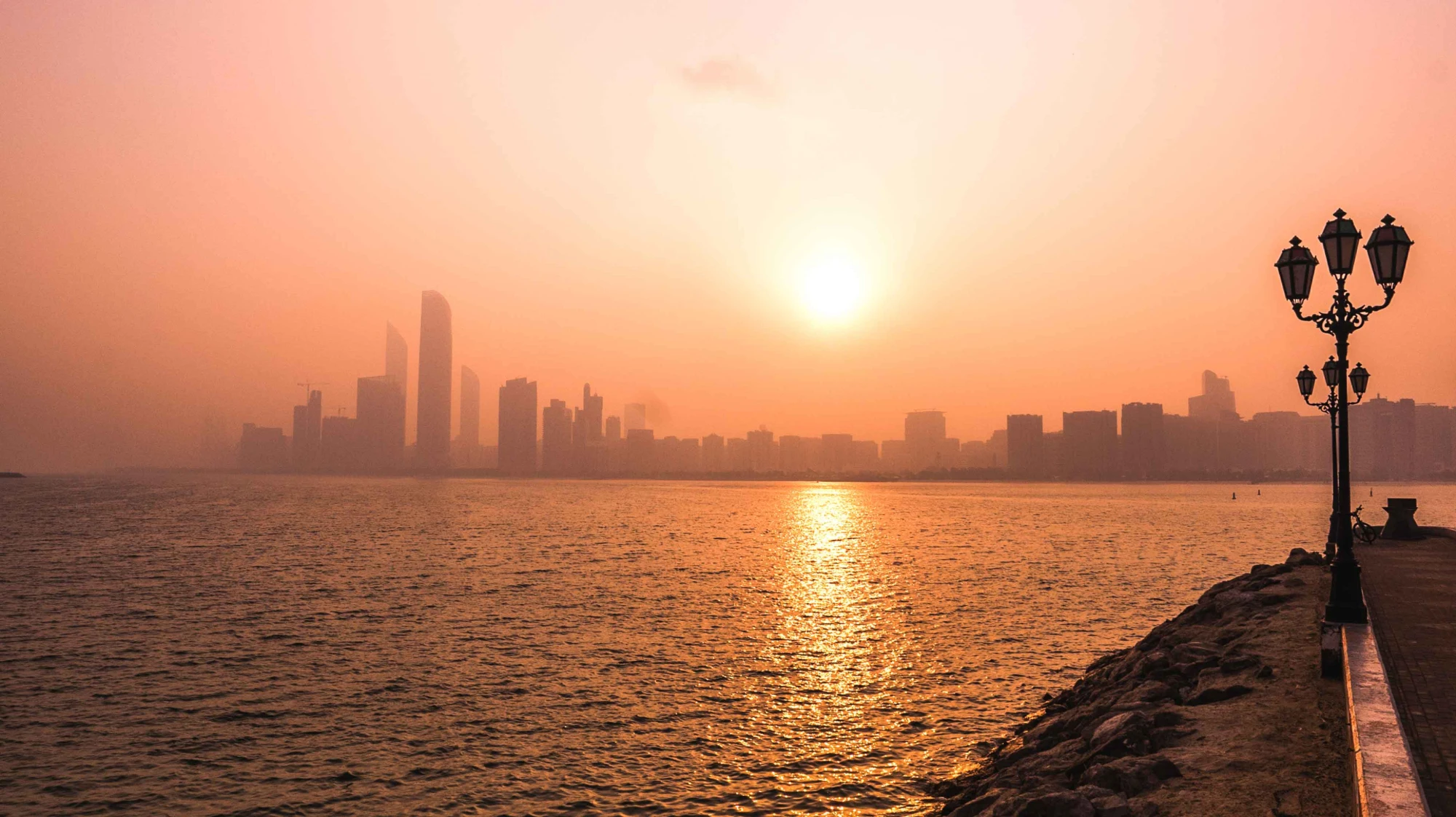 The Abu Dhabi horizon at low sun, seen across flat water
